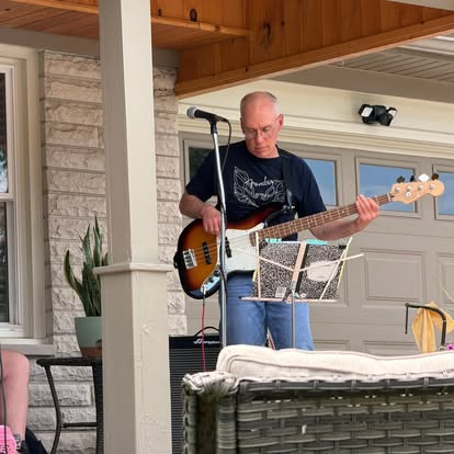 Bud playing bass at an outdoor show.