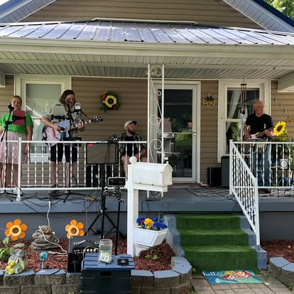 Sarah & Bud playing an acoustic set on a porch.