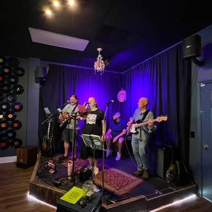 Sarah & the Buds performing on an indoor stage.